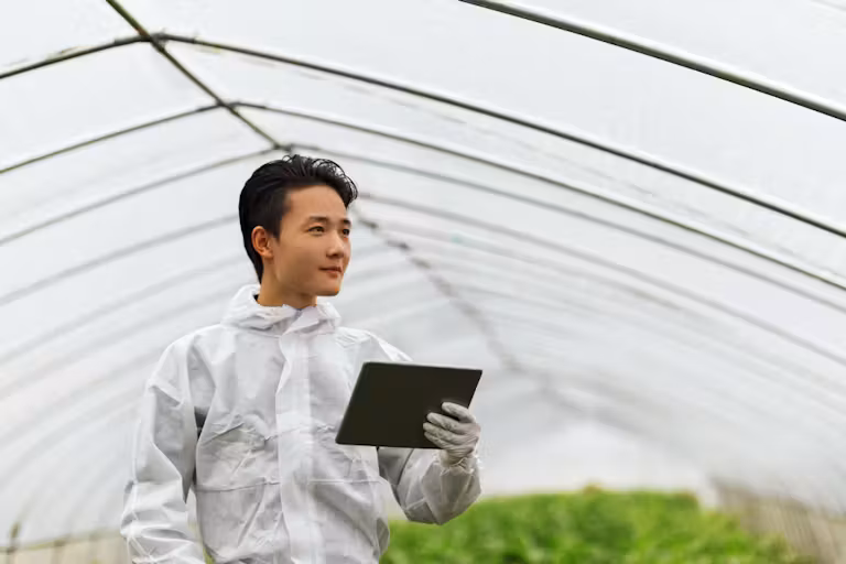 Researcher-standing-in-greenhouse